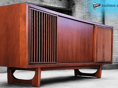 Modern wooden sideboard with horizontal slats and curved legs in a minimalist setting