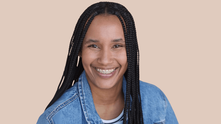 Candyce Denise smiling in a denim jacket, a multi-instrumentalist blending classical, jazz, R&B, and rap in innovative music.