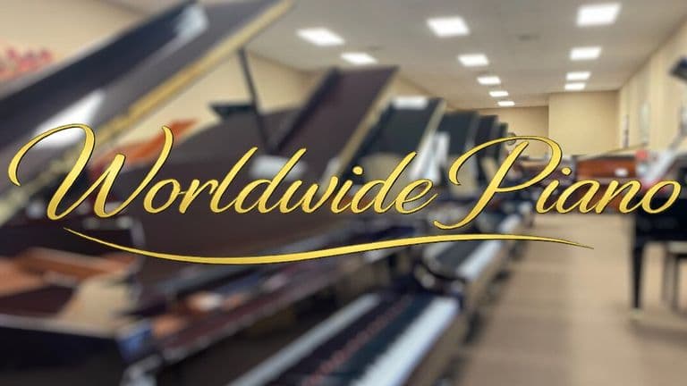 Worldwide Piano logo displayed over a blurred showroom filled with acoustic pianos.