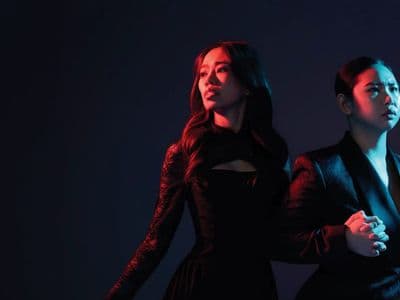 Promotional image for Opera Siam’s Orfeo ed Euridice, showing two performers in dramatic blue and red lighting.
