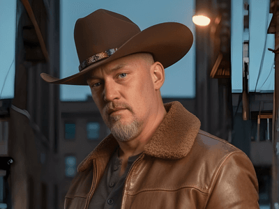 Rob Georg poses in a cowboy hat and leather jacket, reflecting his rugged, heartfelt music style.