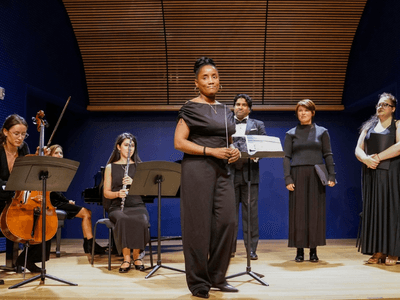 Kervy Delcy leads a performance with her ensemble, inspiring the next generation of musicians through her performing arts school and mentorship.