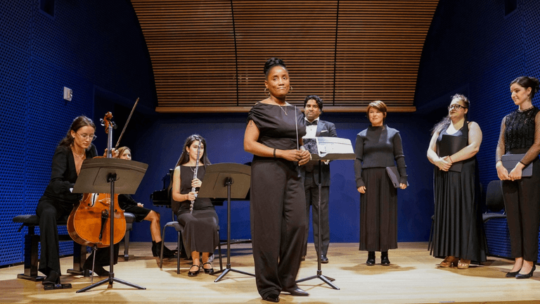 Kervy Delcy leads a performance with her ensemble, inspiring the next generation of musicians through her performing arts school and mentorship.