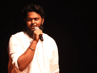 Thivan Sreetharan, a rising star in acting and music, passionately speaks at an event, showcasing his dedication to success.