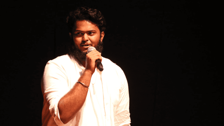Thivan Sreetharan, a rising star in acting and music, passionately speaks at an event, showcasing his dedication to success.