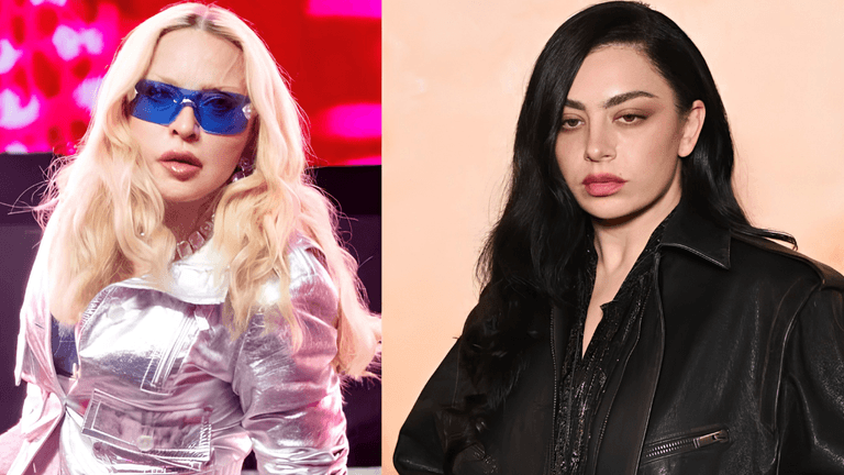 Two women with distinct styles; one in silver attire and sunglasses, the other in black leather.