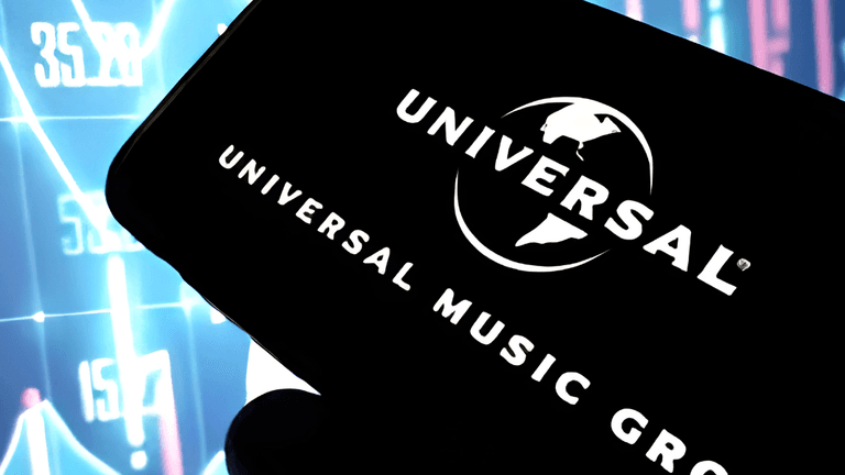 A person holding a smartphone displaying the Universal Music Group logo against a colorful background