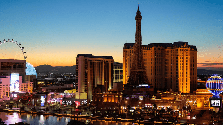 Vibrant Las Vegas skyline at sunset with illuminated buildings and attractions.