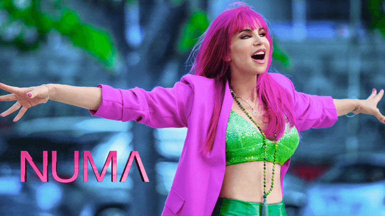 NUMA in vibrant pink and green, embodying empowerment and transformation through music.