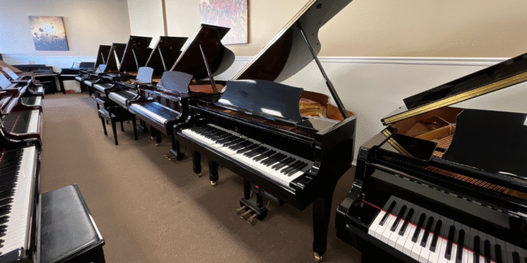 "Showroom with a variety of grand pianos, showcasing craftsmanship and quality at Worldwide Piano."