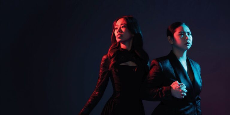 The Long Way Home: Opera Siam’s Thai Buddhist Orfeo Promotional image for Opera Siam’s Orfeo ed Euridice, showing two performers in dramatic blue and red lighting.