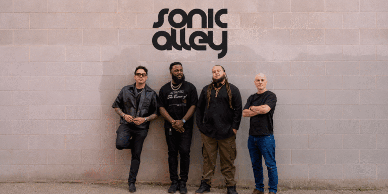 Sonic Alley Introduces Debut Album Unbound Through a Story of Freedom, Culture, and Human Connection Sonic Alley band members standing beneath the Sonic Alley logo against a brick wall.